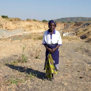 Nagomba E., 75, standing where her house used to be in Mwabulambo, Karonga district. She and her family were told to relocate in 2008 because the land was needed for coal mining. 