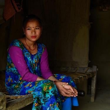 Ganga M., 17, sits inside her home in Kailali, Nepal. Ganga had an arranged marriage at the age of 16 and was five months pregnant when this photograph was taken. Her husband works as a cook in India.
