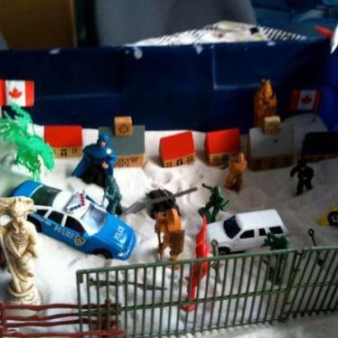 Dominated by symbols of violence, security, and barricades, this sand tray was created by a 12-year-old boy who had been held in a Canadian immigration detention facility for seven months with his mother and older sister. He appeared to have developed mul