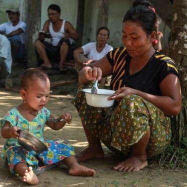 A woman who fled from recent violence in Maungdaw feeds her daughter at a monastery used as a temporary internally displaced persons (IDP) camp in Sittwe, Burma on October 15, 2016.