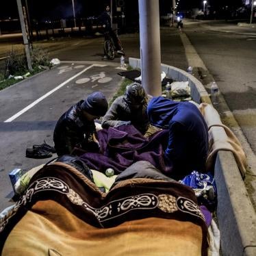 Huddled under blankets, a group of Afghan boys spend the night on the street after French authorities abruptly ended registration and relocation for unaccompanied children who had been staying in the Calais migrant camp, October 26, 2016.