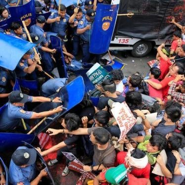 Various activists and indigenous people's groups clash with anti-riot policemen during an anti-U.S. protest in front of the U.S. Embassy in Metro Manila. 