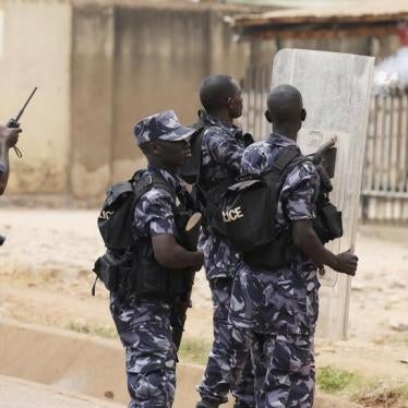A policemen fires a teargas canister in front of opposition leader Kizza Besigye's office in Kampala, Uganda, February 19, 2016.