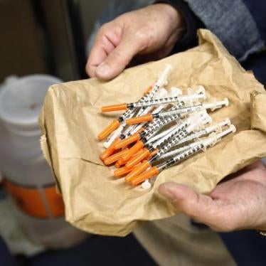 A woman shows her clean syringes at the Aids Center of Queens County needle exchange outreach center in New York, November 28, 2006. 