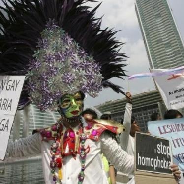 A demonstrator holds signs during an International Day Against Homophobia event in Jakarta, Indonesia on May 17, 2008.