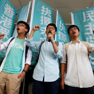 Student leaders Joshua Wong, Nathan Law, and Alex Chow chant slogans before their verdict outside the courthouse in Hong Kong on July 21, 2016.