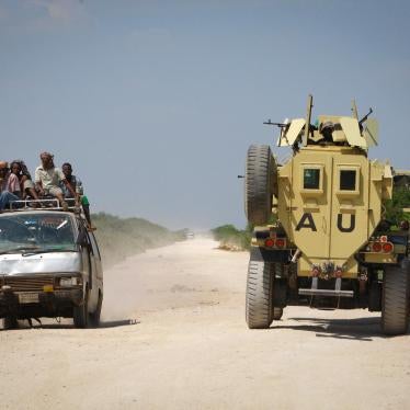 A commuter taxi drives past an African Union Mission in Somalia (AMISOM) armoured vehicle, December 2010 