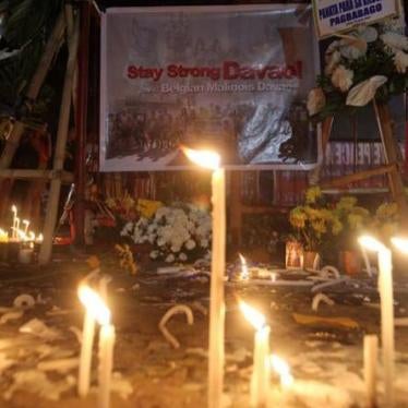 Candles are lit at a memorial site for the victims of the September 2, 2016 explosion in a market in Davao City, Philippines. 