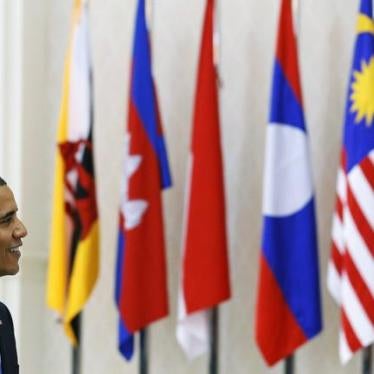 U.S. President Barack Obama passes in front of ASEAN members flags as he arrives for the Plenary session of the 21st ASEAN (Association of Southeast Asian Nations) and East Asia summits in Phnom Penh