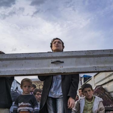 SEPTEMBER 2014. Syrian Kurdish refugees look out from the back of a truck as they enter Turkey from the town of Kobane  (Ayn al-Arab), Syria, and surrounding villages.   © 2014 Michael Christopher Brown/Magnum