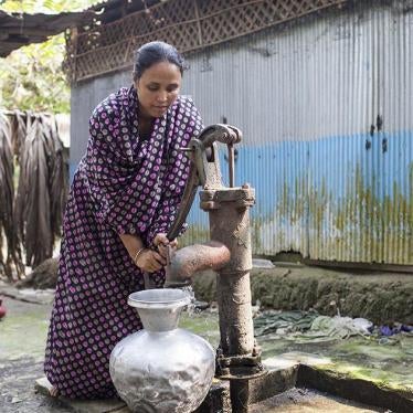 Jhohora Akhter, 30, draws water from the family well, which is contaminated with arsenic. Jhohora’s mother Jahanara Begum died of arsenic-related health conditions. Her father suffers from diabetes, an illness associated with chronic arsenic exposure. Her