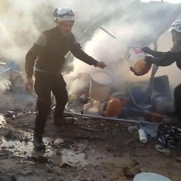 Local Civil Defence Forces extinguishing flames in tent after Syrian government forces shelling hit Khirmash displaced persons camp in Syria on Turkey’s border on April 14, 2016. 