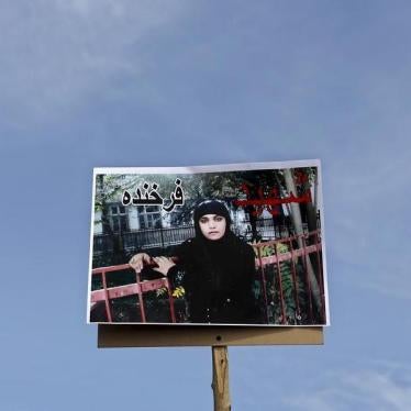 A picture of Farkhunda, an Afghan woman who was beaten to death and set alight on fire on Thursday, is seen during her funeral ceremony in Kabul March 22, 2015.