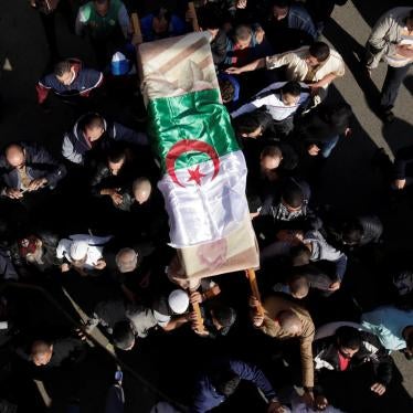 Relatives carry the coffin of British-Algerian journalist Mohamed Tamalt, who had died on December 11 after staging a hunger strike in Algiers over his two years sentence for publishing articles considered as offensive to President Abdelaziz Bouteflika Al