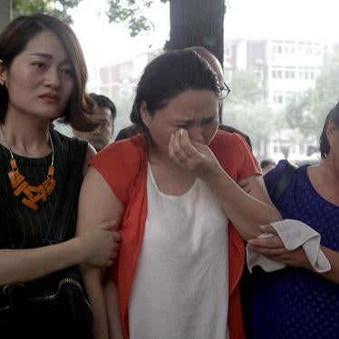 Fan Lili, the wife of imprisoned activist Gou Hongguo, is escorted by Li Wenzu, the wife of imprisoned lawyer Wang Quanzhang, and another woman as they stage a protest outside the Tianjin No. 2 Intermediate People's Court in Tianjin, China on Monday, Augu