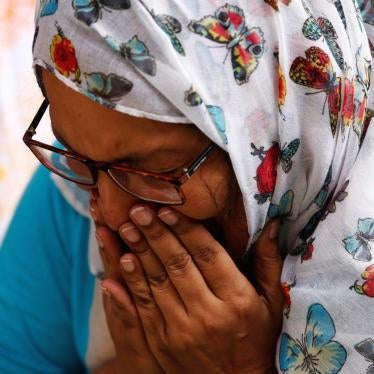 A woman mourns for the victims who were killed in the attack on the Holey Artisan Bakery and the O'Kitchen Restaurant, at a makeshift memorial near the attack site, in Dhaka, Bangladesh, July 5, 2016. 
