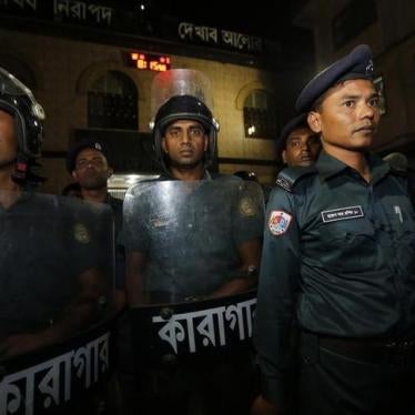 Police stand guard in front of the gate of Dhaka Central Jail on December 10, 2013. 