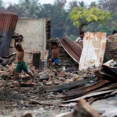 Children recycle goods from the ruins of a market which was set on fire at a Rohingya village outside Maungdaw in Rakhine state, Burma, on October 27, 2016.