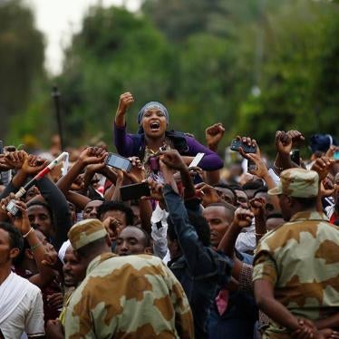 Demonstrators chant slogans while flashing the protest gesture during Irreecha, the thanksgiving festival of the Oromo people, in Bishoftu town, Oromia region, Ethiopia, on October 2, 2016.