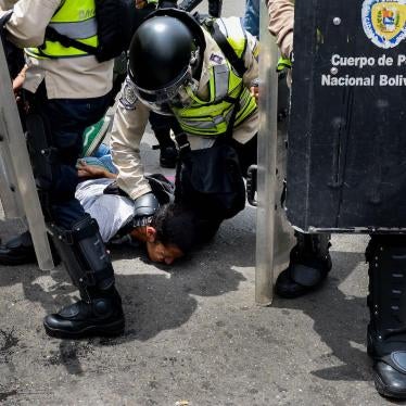 A picture of Venezuelan police arresting a protester.