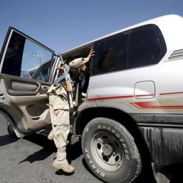A Houthi fighter checks a van at a checkpoint on a street in Yemen's capital Sanaa October 21, 2015.