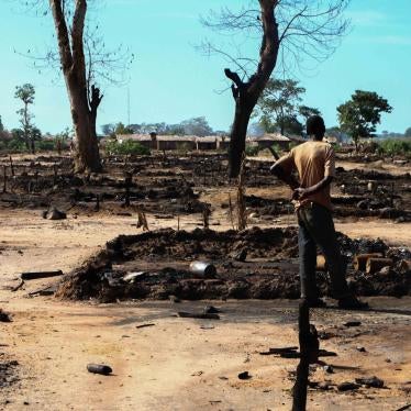A man inspects his burned hut in L’Évêché displacement camp, Central African Republic, on October 12. Seleka forces burned at least 435 huts in the camp. 