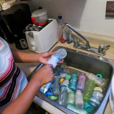 Roxanne Moonias, mother to an infant with a chronic illness, demonstrates one of the steps she takes to ensure her baby is not exposed to contaminants in the water. Roxanne lives in Neskantaga First Nation and says that it takes her an hour each time to p
