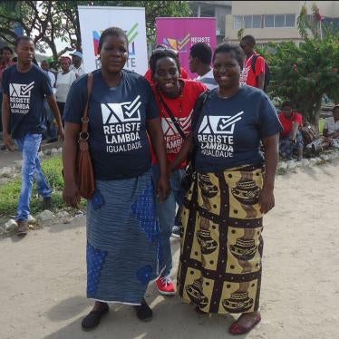A member of Lambda Mozambique is joined by relatives during an event to raise awareness about HIV/Aids, December 2014.