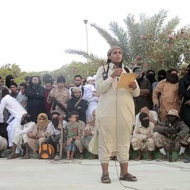 An ISIS official makes an announcement ahead of the execution of two men for “sorcery” in Sirte, Libya. Image from a 2015 Islamic State (ISIS) video. The online clearinghouse Jihadology.net posted the video on its website.