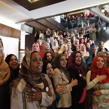 Women candidates sing the national anthem before taking a group photo at a conference to empower women voters and politicians in Tripoli June 25, 2012.