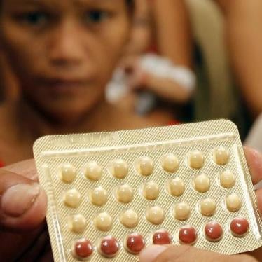 An NGO health worker holds contraceptive pills during a family planning session with housewives availing free pills in Tondo, Manila August 6, 2012. 