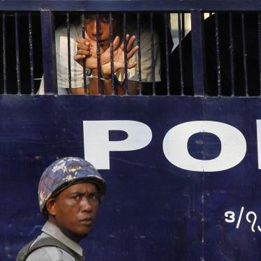 A student protester peers out of a prison vehicle as he is transported to court in Letpadan on March 11, 2015.