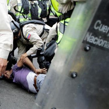 Riot police officers detain a demonstrator during clashes with opposition supporters in a rally to demand a referendum to remove President Nicolás Maduro in Caracas, Venezuela, on May 18, 2016. 
