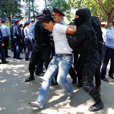 Police arrest protester in Kazakhstan. 