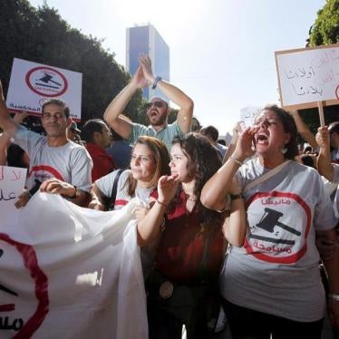 Protesters shout slogans during a demonstration against the economic reconciliation bill at Bourguiba Avenue in Tunis