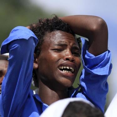 A man mourns during the funeral ceremony of a primary school teacher who family members said was shot dead by military forces during protests in Oromia, Ethiopia in December 2015. December 17, 2015. 