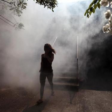 A woman walks away from her apartment as health workers fumigates the Altos del Cerro neighborhood as part of preventive measures against the Zika virus and other mosquito-borne diseases in Soyapango, El Salvador January 21, 2016.