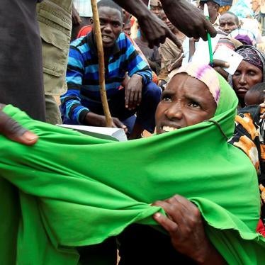 A newly arrived Somali refugee is forced out of the queue outside a reception centre in the Ifo 2 refugee camp in Dadaab, near the Kenya-Somalia border, in Garissa County, Kenya