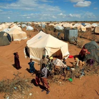 Photo: Refugees stand outside their tent at the Ifo Extension refugee camp in Dadaab, near the Kenya-Somalia border in Garissa County, Kenya, October 19, 2011. 