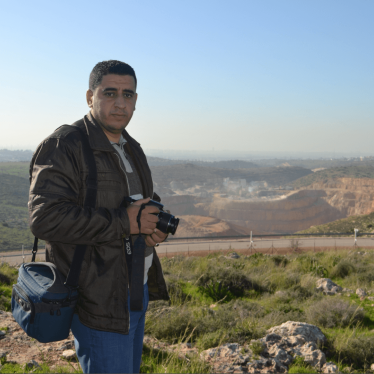 Azmi Shuqeir, of the West Bank village of Zawiya, in front of a quarry that a multinational company operates on land confiscated by Israel. 
