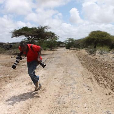  مصور صحفي صومالي يحاول الاحتماء خلال تغطية القتال بين قوات الحكومة الصومالية و"الاتحاد الأفريقي" من جهة، والمجموعة الإسلامية المسلحة "الشباب" من جهة أخرى في منطقة شابيل السفلي في الصومال، أبريل/نيسان 2012