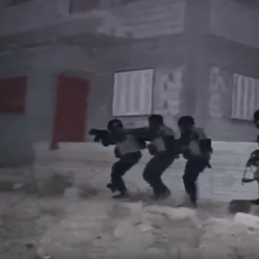 Still from a video published by the Egyptian Interior Ministry. The video shows commandos stealthily approaching a building. But military experts said the bright, white light illuminating the commandos during their approach was one indication that the rai
