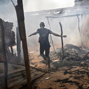 A man runs through looted and burned homes in the Muslim neighborhood of PK13 located on the outskirts of Bangui, Central African Republic.