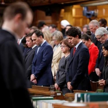 Canada's Prime Minister Justin Trudeau (front, 2nd R) joins fellow MPs in a moment of silence after delivering a statement on a deadly shooting at a Quebec City mosque, in the House of Commons on Parliament Hill in Ottawa, Ontario, Canada, January 30, 201