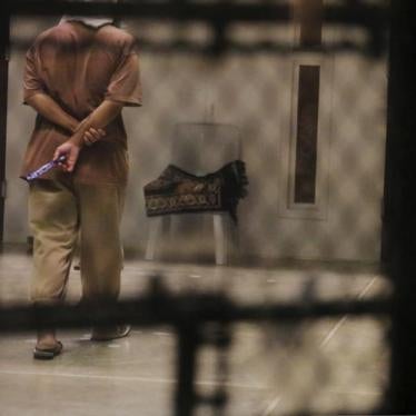 A detainee paces around a cell block while being held in Joint Task Force Guantanamo's Camp VI at the U.S. Naval Base in Guantanamo Bay, Cuba March 22, 2016.