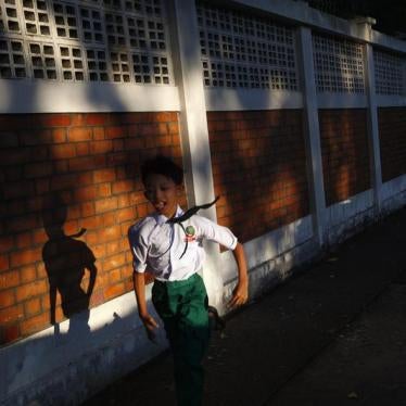 A boy runs as he exits his school in Yangon, November 6, 2013. 