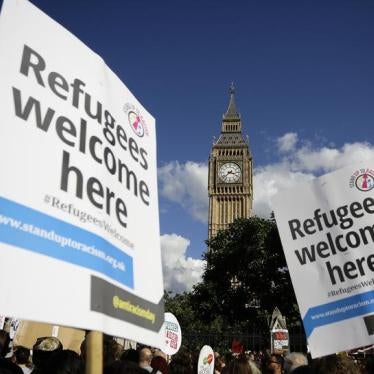 Protesters hold up placards during a demonstration to express solidarity with migrants and to demand the government welcome refugees into Britain, in London, September 12, 2015.