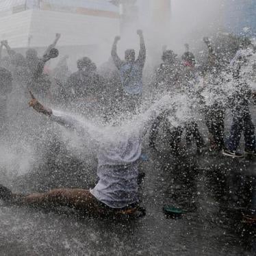 Protesters react as police spray water canon to disperse them during a rally calling for their right to self-determination in the Indonesian controlled part of Papua, in Jakarta, Indonesia, December 1, 2016.