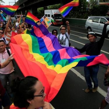 Supporters wave rainbow flags while marching during a LGBT Pride parade in metro Manila, Philippines June 25, 2016.