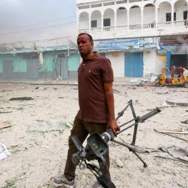 Somali Freelance journalist Mohamed Guray holds his camera after he was injured in a secondary explosion in front of Dayah hotel in Somalia's capital Mogadishu, January 25, 2017.